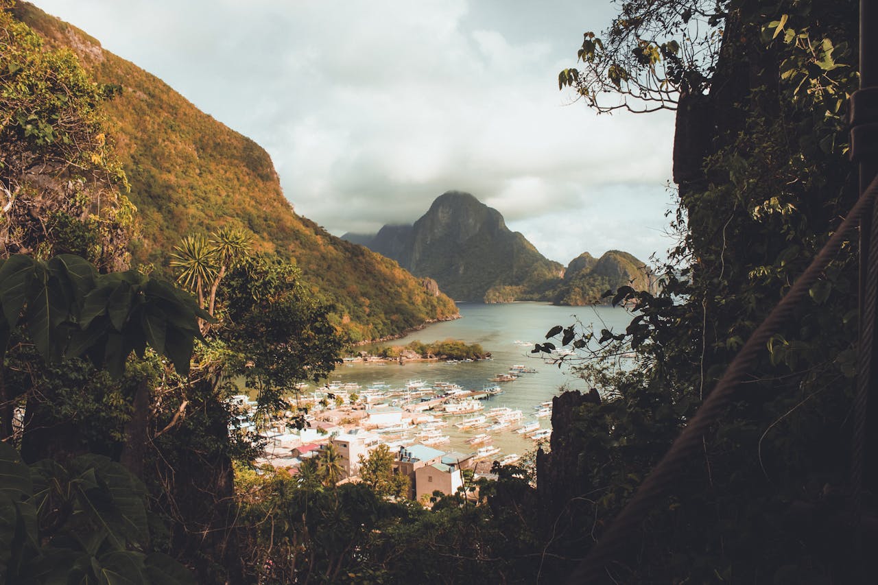 Breathtaking view of El Nidos lush mountains and serene waters in the Philippines.